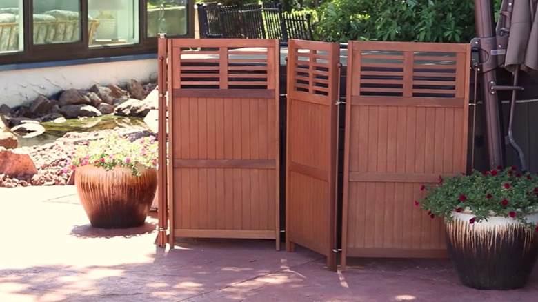 a set of four folding panels is used to hide a group of electrical boxes
