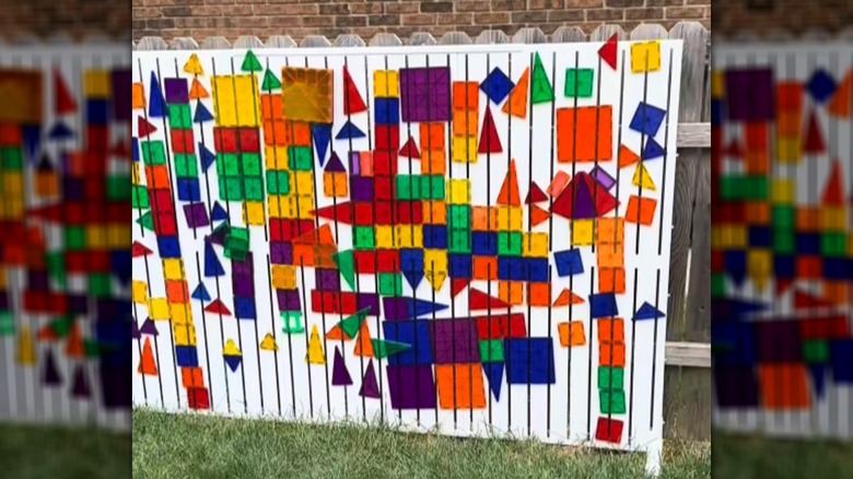 magna-tiles on an outdoor magnet board that could be used to hide electrical eyesores
