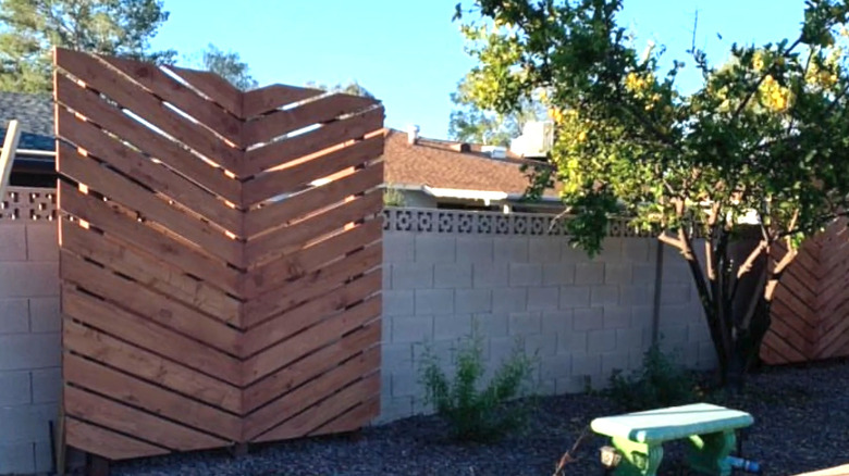 a diy wooden privacy screen can be used to hide an electrical fixture or outlet