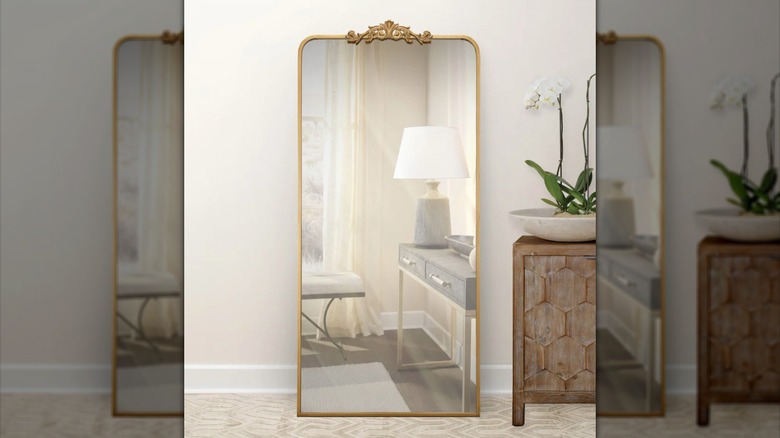 Ravena floor mirror with gold trim in home