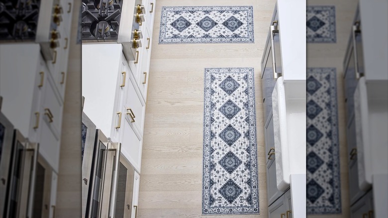 Two white and blue accent rugs in kitchen