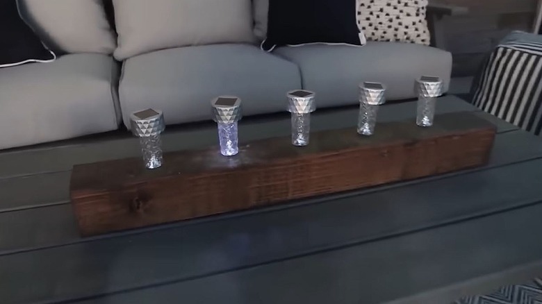 A solar light centerpiece on an outdoor coffee table.