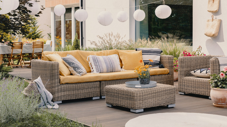 Rattan furniture on patio with colorful cushions and seat