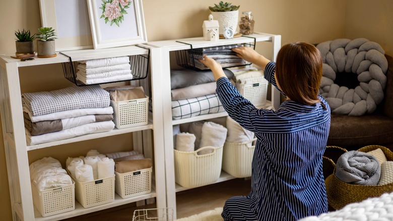 woman organizing shelves in home