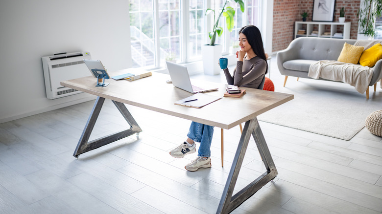 Woman in a simple and organized home office