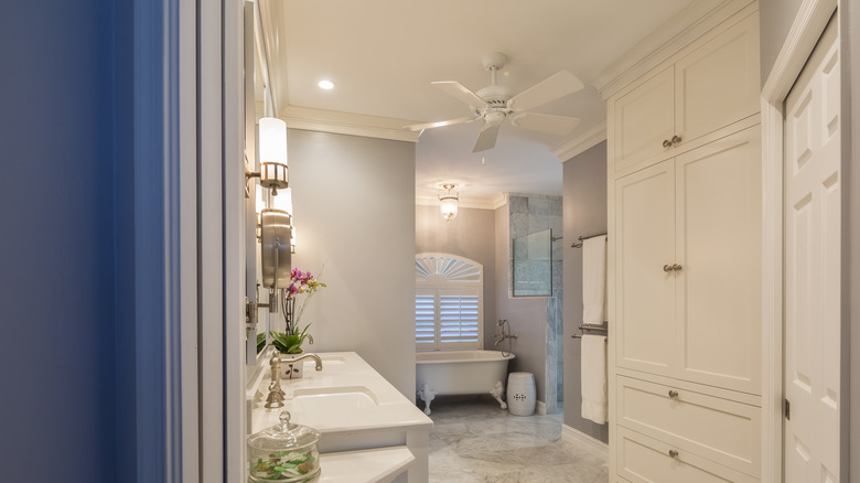 White ceiling fan in a white bathroom.