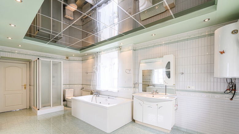 A large, white bathroom with a grid mirror ceiling.