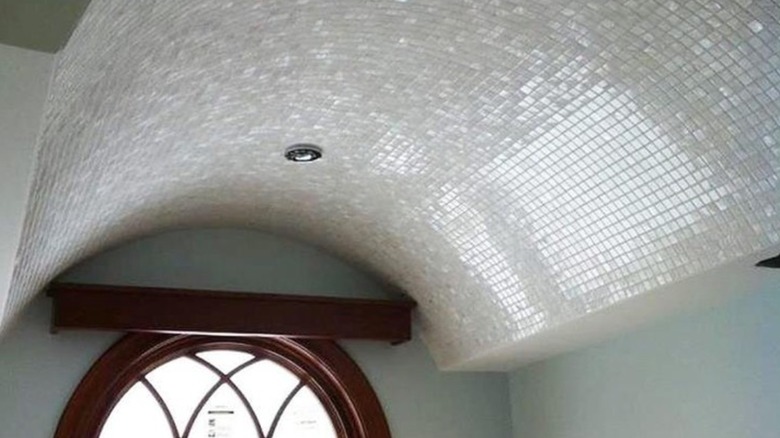 Arched small mosaic tile ceiling in bathroom.