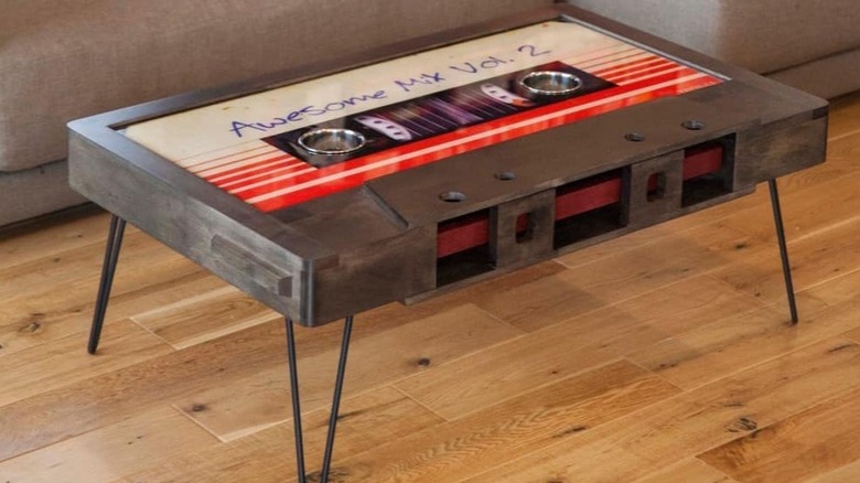 A mix tape coffee table in front of a brown sofa.