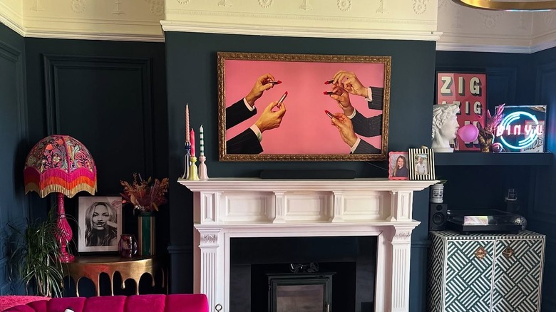 A living room with a white fireplace surround and quirky art pieces.