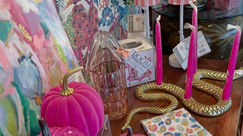 Neon pink candles on a gold serpent candle holder.