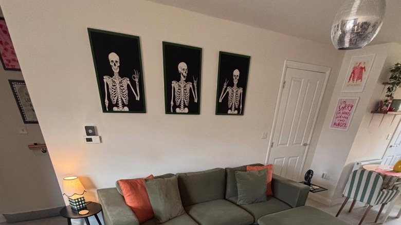 Friendly skeleton wall art on a white living room wall.