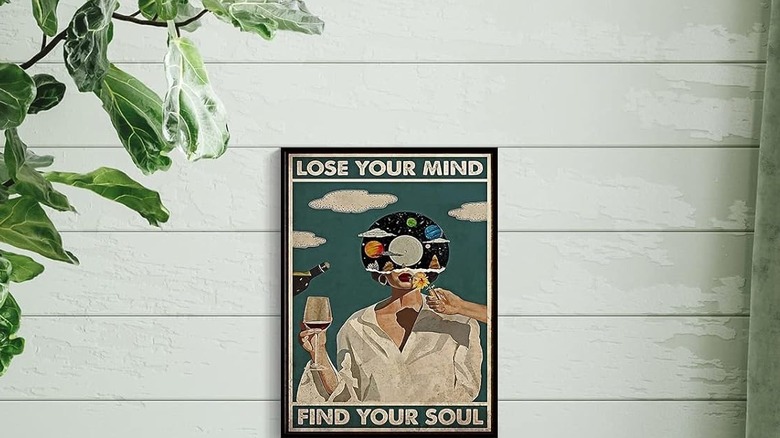 Wall art depicting a person with an outer space head and the phrase "Lose your mind; find your soul."