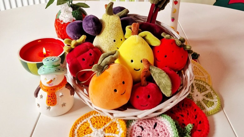 A fruit basket filled with adorable stuffed toy fruit.