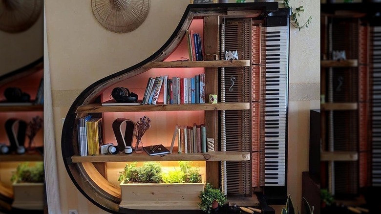 A large piano gutted and turned on its side with shelves added.