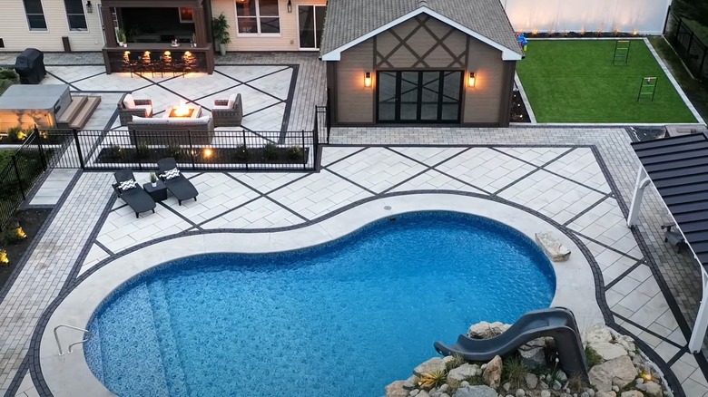 Backyard with a pool and lounging spaces
