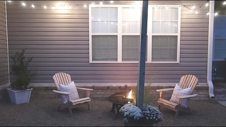 Adirondack chairs and firepit outside a house