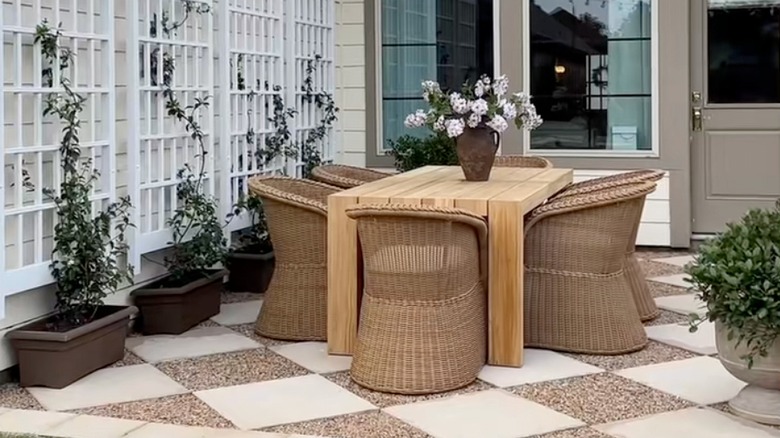 Outdoor patio furniture sitting on checkerboard tiles