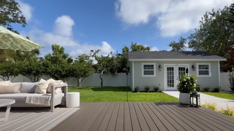 Polished space with floating deck and storage shed
