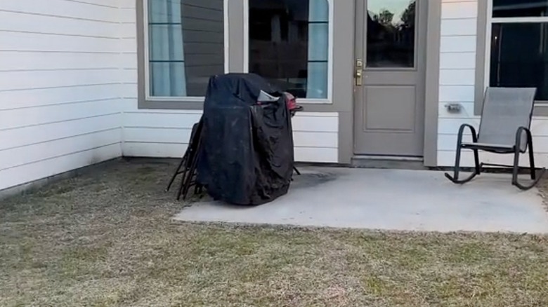 Concrete slab with a barbecue grill and grass