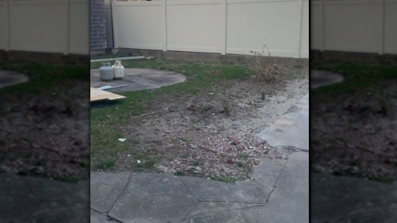 Concrete slab with outdoor tools in a trash can