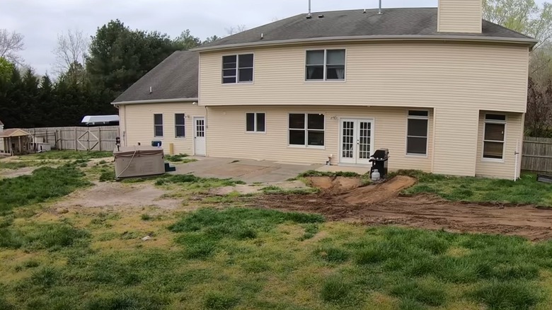 An empty backyard behind a house
