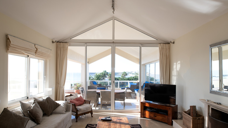 Vaulted ceiling living room with connected patio