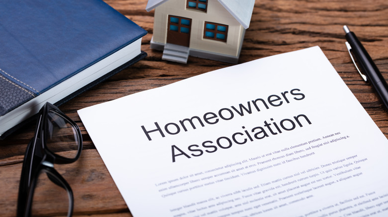 Homeowners Association paperwork on a wooden desk