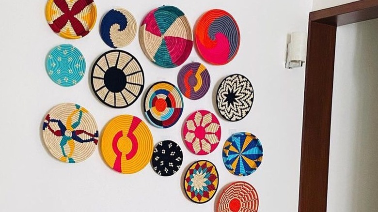 Colorful baskets hanging against a white wall