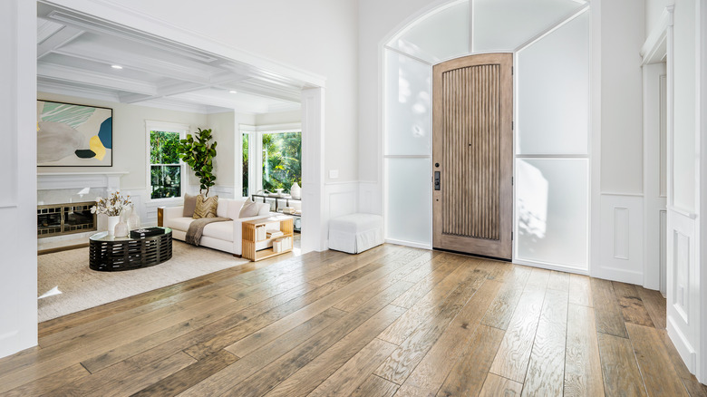 Wood floors and white furniture in a home's entryway