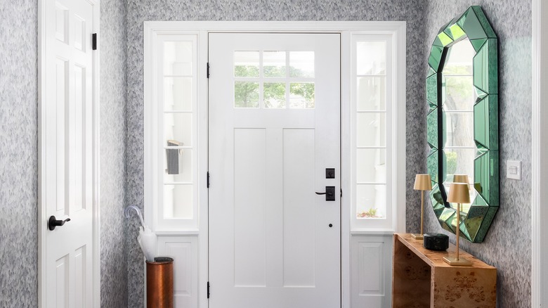 An elegant wallpaper covering the walls near an entryway