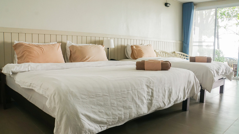 wood-paneled room with two beds