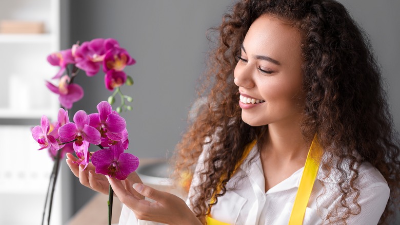 Woman tending orchid