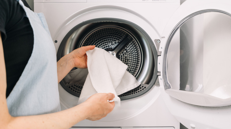 Person washing towels in washing machine