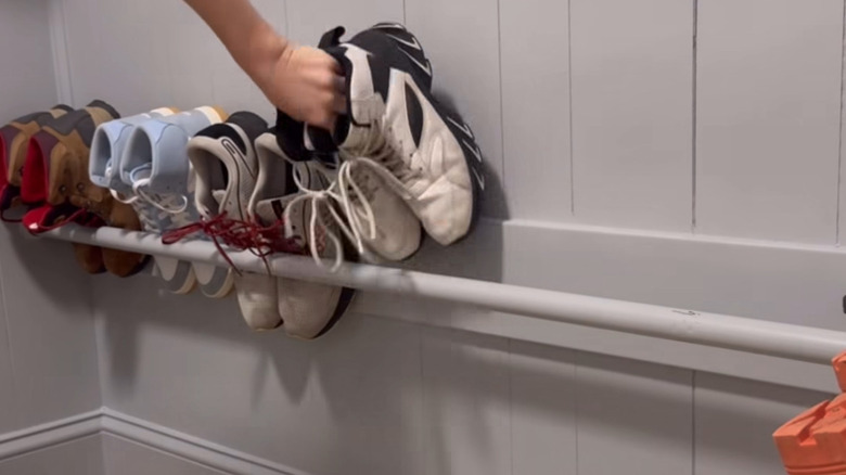 a closet rod or dowel spanning from wall to wall makes a good shoe storage