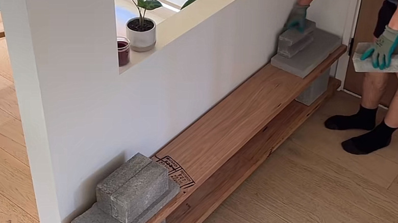 concrete blocks and pavers can be stacked to make shoe shelves of any height