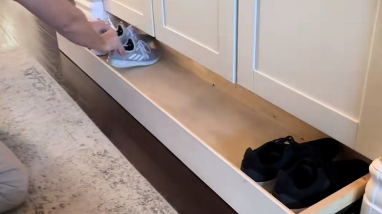 underneath a cabinet where the toekick plate is makes good shoe storage