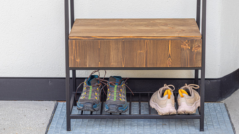 running and hiking shoes on a shoe rack outside
