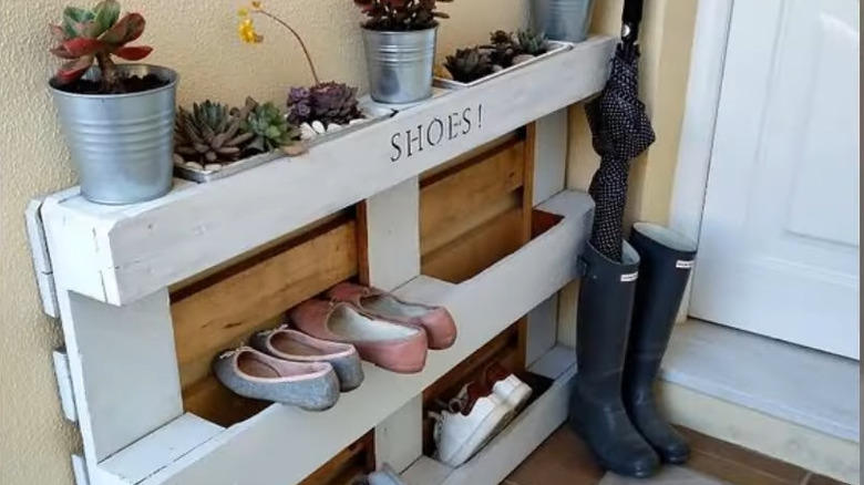 a pallet can be painted and decorated an turned into a useful shoe storage rack