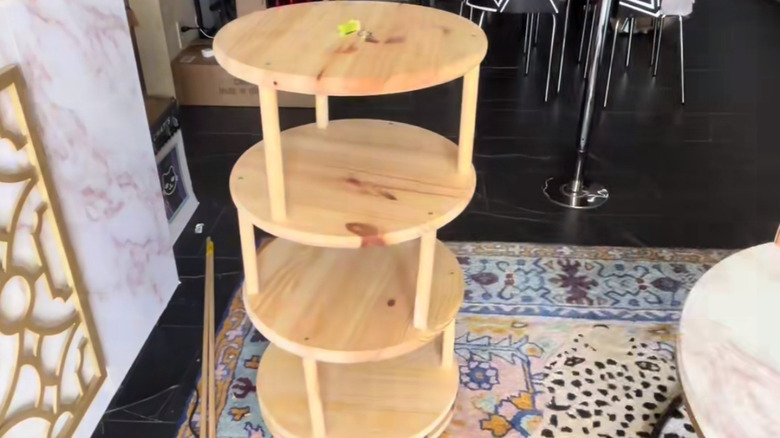 a spinning shoe storage rack is easily assembled from dowels and round wood bases and a lazy susan turntable