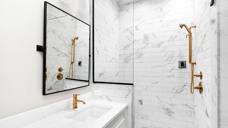 gold faucets in white bathroom