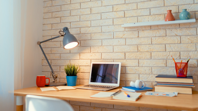 desk up against brick wall