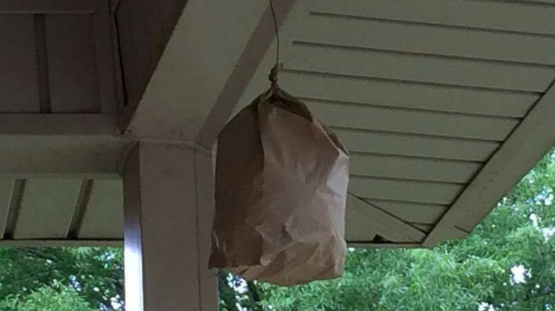 A brown bag hanging on porch.