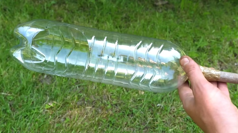 a fruit picker made from a plastic drink bottle