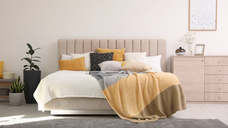 yellow blanket draped on bed
