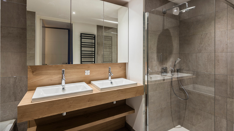 Large grey stone tiled bathroom