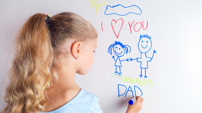 girl drawing on whiteboard