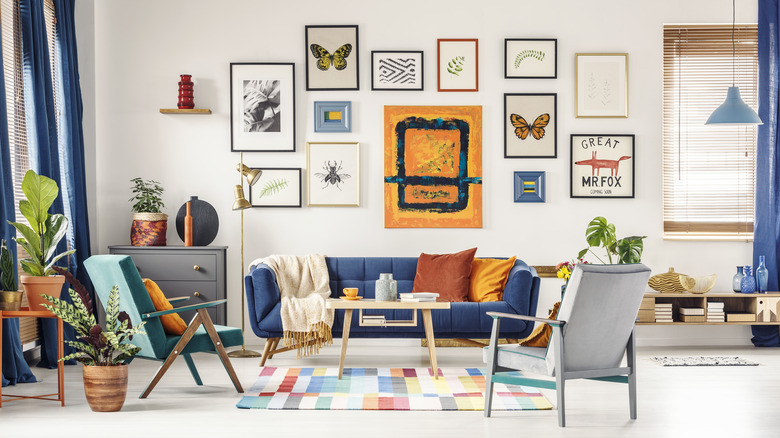 living room gallery accent wall with paintings and photos