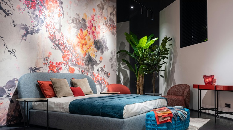 pink, orange, and gray floral accent wall behind bed