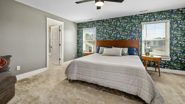 subtropical green wallpaper accent wall in bedroom